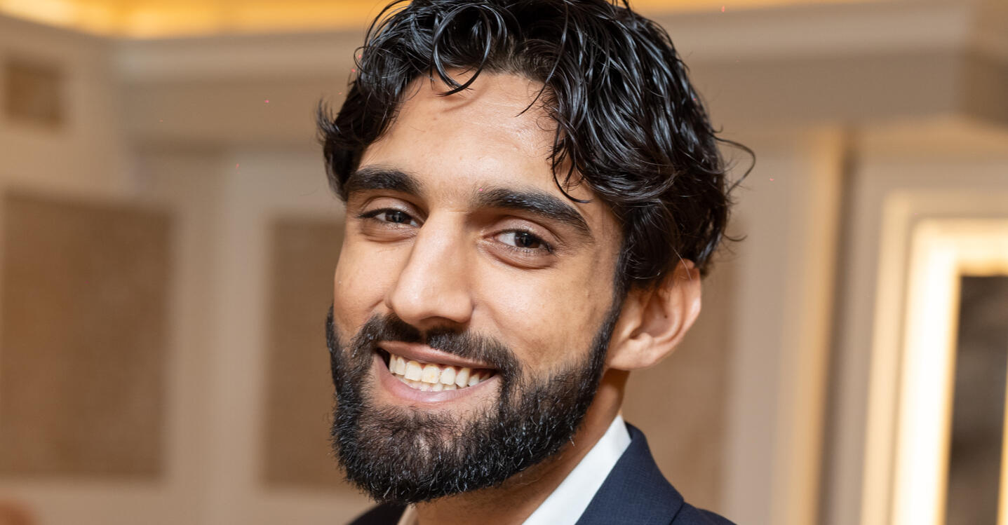 Portrait of Mavin Kakkar standing outdoors in natural light, wearing earth-toned clothing with a calm, grounded expression. A soft background of trees and sky adds to the peaceful, spiritual vibe. This image represents the guide behind The Mavin Strategy.”